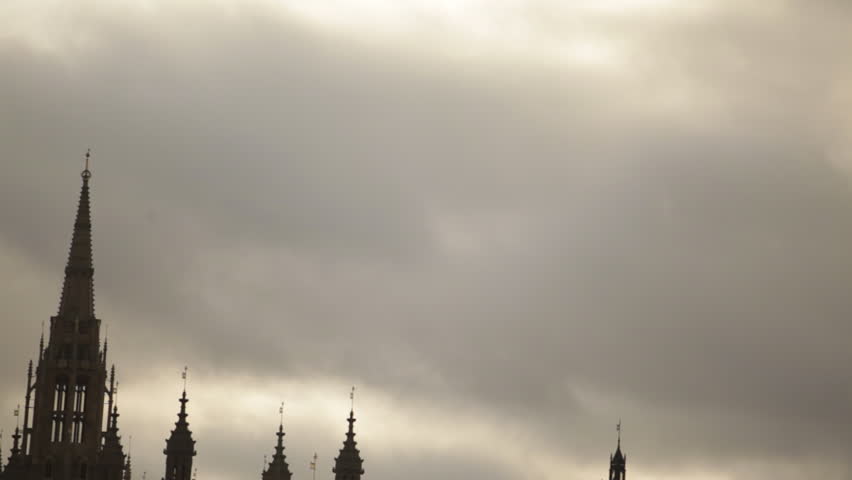 Traveling view of Victoria Tower to Big Ben and Westminster Palace, dark clouds