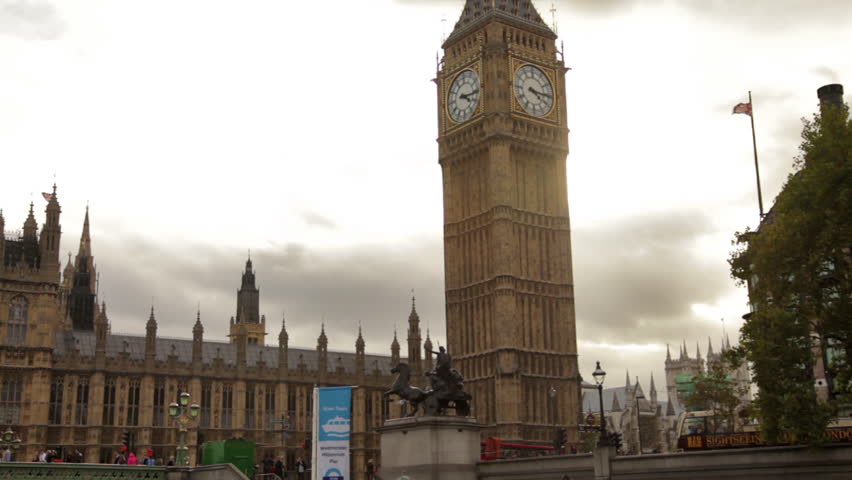 Big Ben and Westminster palace with cloudy sky background in London, England.