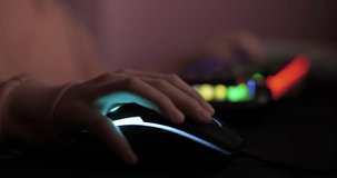 RGB Mouse. Close up Hand of Gamer Girl, Moving Mouse While Playing PC Game. Person Plays Computer Video Game in Dark Room, Cyber sport Gaming, Children Gaming Addiction. Video Game Live Streaming.