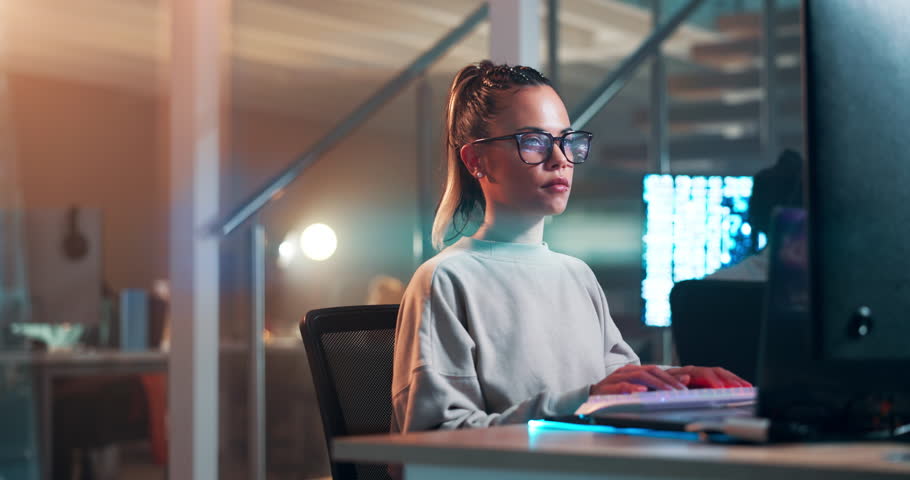 Programmer, typing and woman on computer at night and writing code and thinking about information. IT, professional and person with analysis of software for cybersecurity and research for project