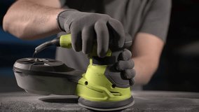 close up of an electric sander.man doing manual work. Slow motion video. High quality video in 4K format.