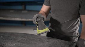 close-up of an electric sander.close-up of a hand-held power tool.man doing manual work. Slow motion video. working with fiberglass. High quality video in 4K format.