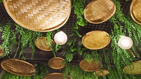 Woven bamboo baskets on a wall with green ferns creating a natural and rustic decorative interior background design asia india - Powered by Shutterstock - Get 15% off with code: PIKWIZARD15