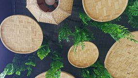 Woven bamboo baskets on a wall with green ferns creating a natural and rustic decorative interior background design asia india - Powered by Shutterstock - Get 15% off with code: PIKWIZARD15