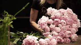 Florist Crafting Bouquet. Florist's Bouquet Design. Florist at Work. Florist's Creative Process. Florist makes bouquet in flower shop. Florist making bouquet of flowers in flower shop in Lviv - Powered by Shutterstock - Get 15% off with code: PIKWIZARD15