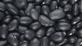 Vertical video. Top closeup view of black beans. Food backdrop.