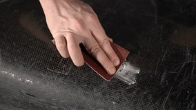 close up of sandpaper.man doing manual work. Slow motion video. working with fiberglass. High quality video in 4K format.