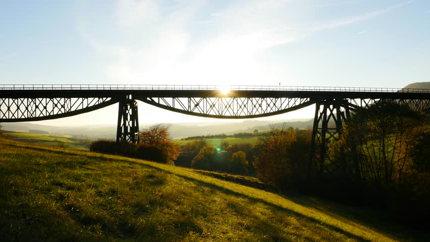 Locomotive Crossing a Rural Bridge during Midday