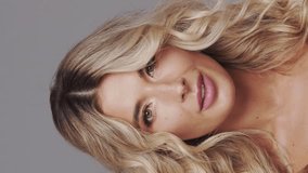 Studio portrait of young and beautiful blond woman over grey background. Skin care and wellness concepts. - Powered by Shutterstock - Get 15% off with code: PIKWIZARD15