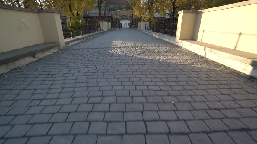 Cobblestone bridge in Oslo Norway during sunny fall day in front of castle