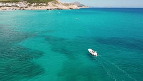 The beautiful waters of the island of Mallorca, several boats appear to show the cove.