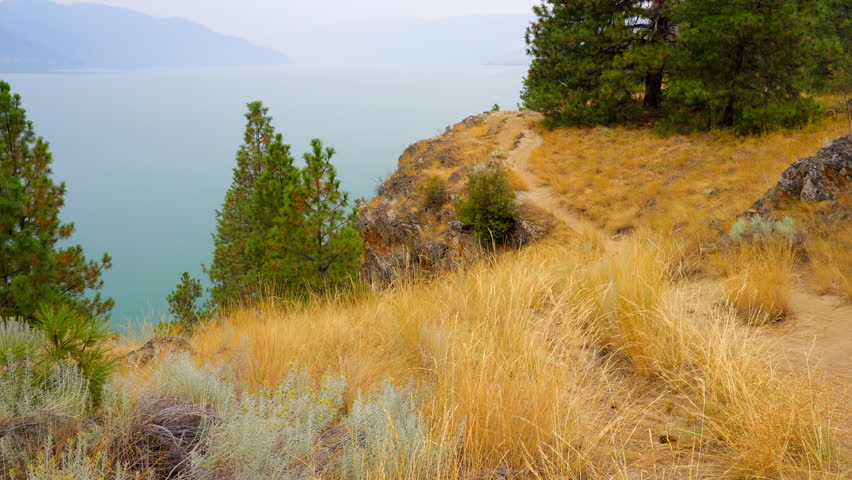 Establishing shot of trail in mountain lake in slow motion at in Vancouver, Canada, North America. Day time on Jun 2023. Still camera. ProRes 422 HQ.