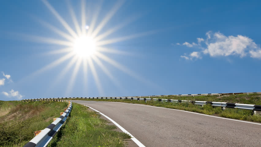 asphalt road under a sparkle sun time lapse scene