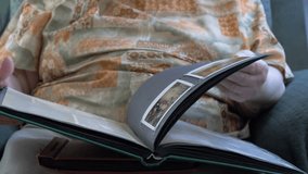 Senior woman is watching album with an old photos - Powered by Shutterstock - Get 15% off with code: PIKWIZARD15