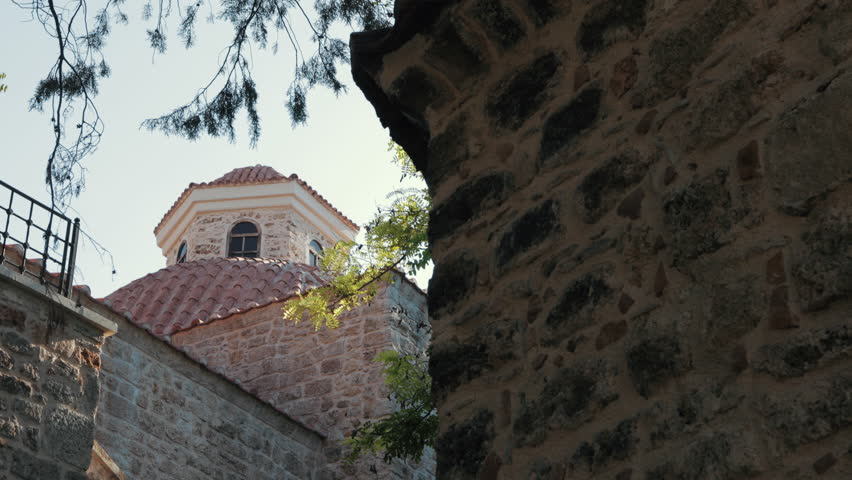 It is the dome of the historical Mevlevihane building in Antalya Kaleiçi. Cut stone and brick workmanship can be seen. The camera pans from below. Royalty-Free Stock Footage #3438811251