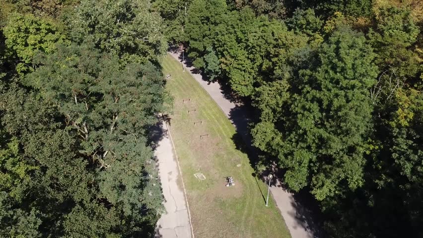 travel drone shot european green public park with excercise tools entrance empty