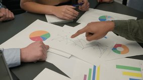 Close up table with papers documents unknown group of business men women discuss marketing research results review sales statistics data information analysis graphs charts planning strategy at office - Powered by Shutterstock - Get 15% off with code: PIKWIZARD15