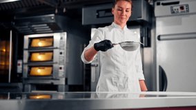 A girl chef-baker sifts flour through a sieve on a kitchen surface to prepare dough for baking baked goods - Powered by Shutterstock - Get 15% off with code: PIKWIZARD15