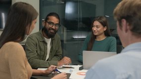 Business team multi ethnic women men group co-workers colleagues young creative managers sit at office conference table share ideas discuss startup project corporate brainstorm negotiate at workplace - Powered by Shutterstock - Get 15% off with code: PIKWIZARD15