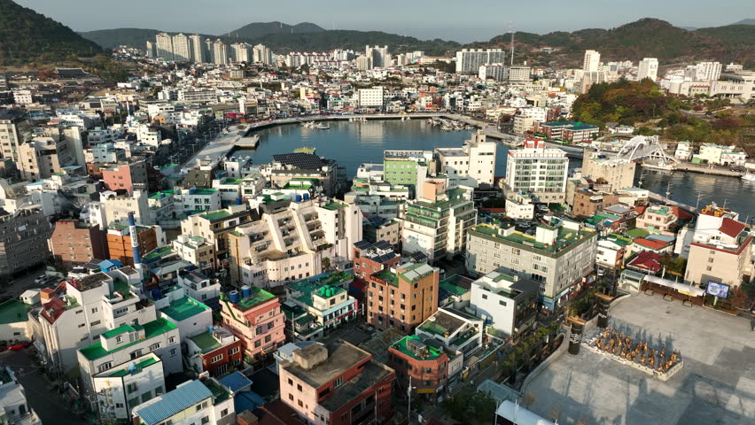 Aerial view of Tyongyeong, South Korea, a coastal city located in Gyeongsang Province in the fall. Slow fly forward shot in the evening.