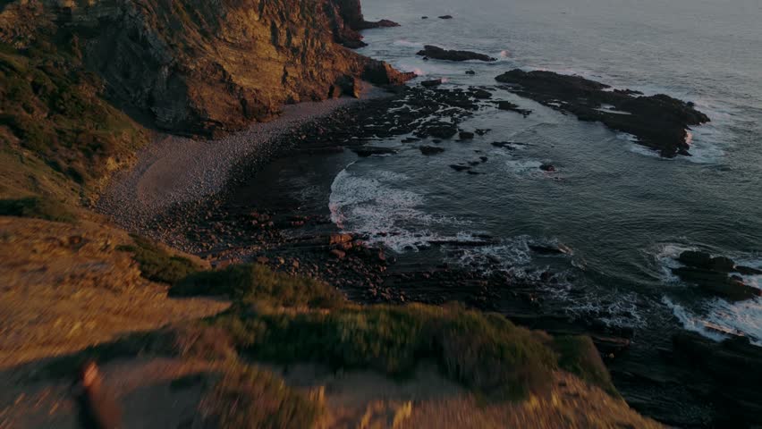 Rugged Rocks And Cliffs On The Coastline Of Portugal During Sunset. Aerial Drone Shot
