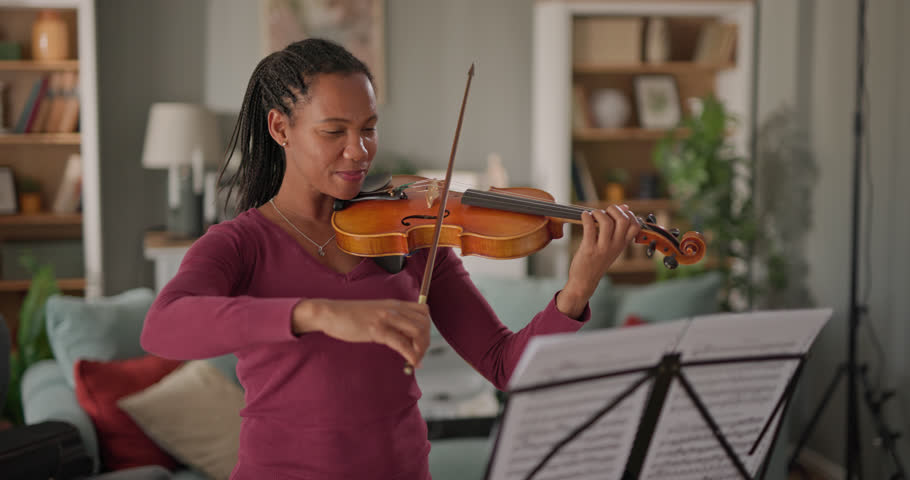 African American woman playing violin at home Royalty-Free Stock Footage #3438849755