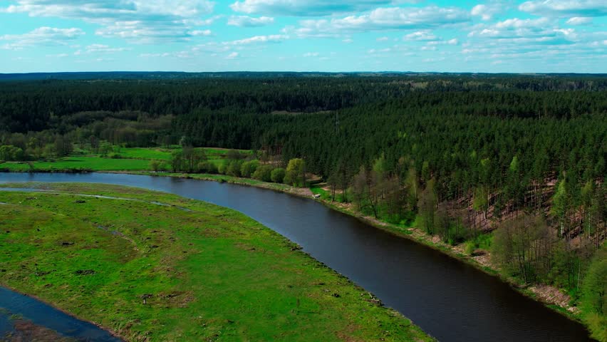 Flying over a river Nemunas and forest in Lithuania near Merkine.
Aerial  drone view of beatyful nature of Lithuania Royalty-Free Stock Footage #3438857871