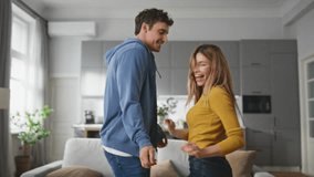 Happy family enjoying dance in living room closeup. Smiling boyfriend girlfriend having fun together in light apartment. Cheerful couple dancing in modern home. Positive people lifestyle concept - Powered by Shutterstock - Get 15% off with code: PIKWIZARD15