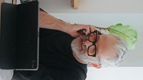 Creative designer talking mobile phone at cafe vertical closeup. Successful senior work computer discussing business ideas on call. Handsome illustrator elderly freelancer with piercing making order - Powered by Shutterstock - Get 15% off with code: PIKWIZARD15