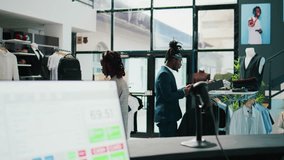 Pregnant woman looking at trendy merchandise on stand hangers, shopping for pregnancy clothes in fashion store at mall. African american client searches fashionable items on discount. Camera B. - Powered by Shutterstock - Get 15% off with code: PIKWIZARD15