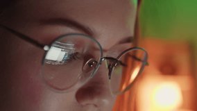 Closeup of Young Adult Women Wearing Reflective Eye Glasses Analyzing Cyber Security Code Data Working Night Concentrating Computer Screen Financial Virus Hacker Female Dark Programmer Crypto BTC 4K - Powered by Shutterstock - Get 15% off with code: PIKWIZARD15