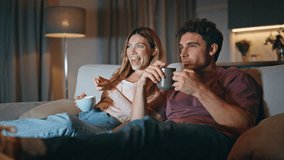 Excited family watch comedy movie have good time in evening living room together closeup. Happy man pretty woman talking with surprised expression on sofa. Love couple enjoy funny video blog at home  - Powered by Shutterstock - Get 15% off with code: PIKWIZARD15