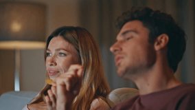 Talking friends eating snacks at home cinema place closeup. Young family watching movie together. Laughing pair enjoying tv show sipping beer bottles in living room. Weekend entertainment concept  - Powered by Shutterstock - Get 15% off with code: PIKWIZARD15