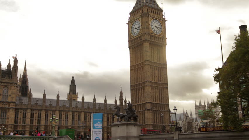 Big Ben and Westminster palace with cloudy sky in background in London, England.