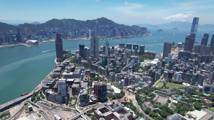 Aerial drone skyview of Hong Kong West Kowloon Victoria Harbour Financial Tsim Sha Tsui Hung Hom Central Admiralty Wan Chai Happy Valley Causeway Bay Mong Kok Royalty-Free Stock Footage #3438997219