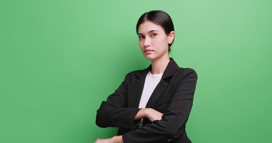 Portrait of attractive businesswoman in a suit. Isolated on green background in studio. Royalty-Free Stock Footage #3438998265