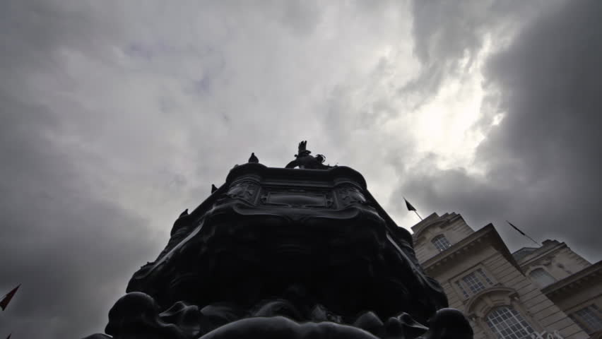 Birds flying around the Eros statue in London