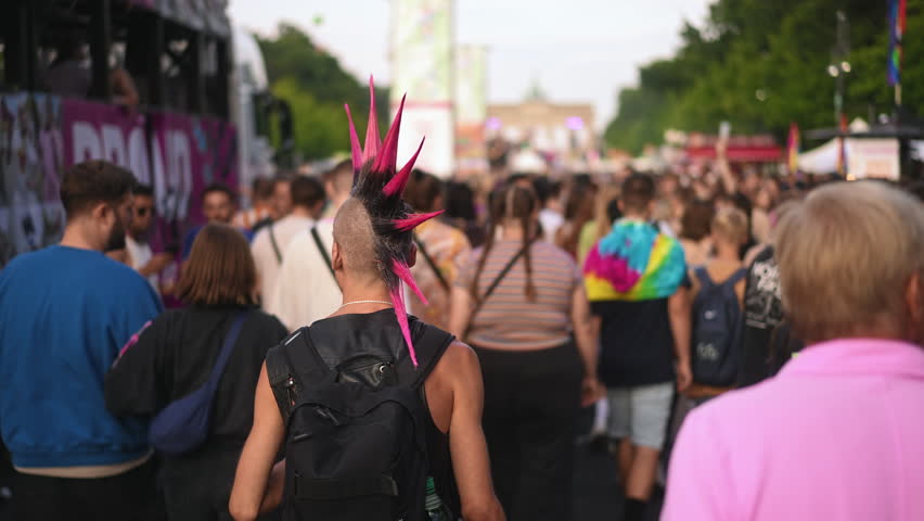 Cool punk rocker dyed mohawk hairstyle. Dressed up hipster enjoy hard rock music fest. Fun male carnival retro hair style. Fan stylish haircut. Queer lgbt pride party. Joyful gay person walk csd day.