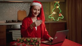 A woman wearing a Santa hat is entering her bank card information on a laptop while online shopping, surrounded by festive Christmas decor. - Powered by Shutterstock - Get 15% off with code: PIKWIZARD15