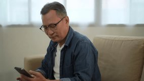 Happy asian retired man making call with smart phone, retirement look at tablet with happy face expression, elderly man enjoy online communication technology, entertainment and joyful of grandpa - Powered by Shutterstock - Get 15% off with code: PIKWIZARD15