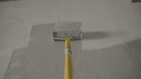 Painting Grey wall with paint roller . Close Up Shot of White Paint being applied on a wall. Room Renovations at Home concept. Painter man painting the wall in home. Camera attached to the brush - Powered by Shutterstock - Get 15% off with code: PIKWIZARD15