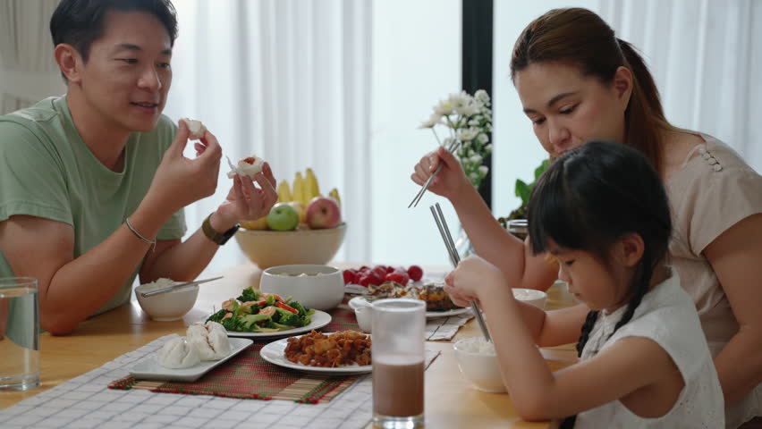 Asian family eating breakfast at the dining table inside the kitchen, family relationships
 Royalty-Free Stock Footage #3439141313