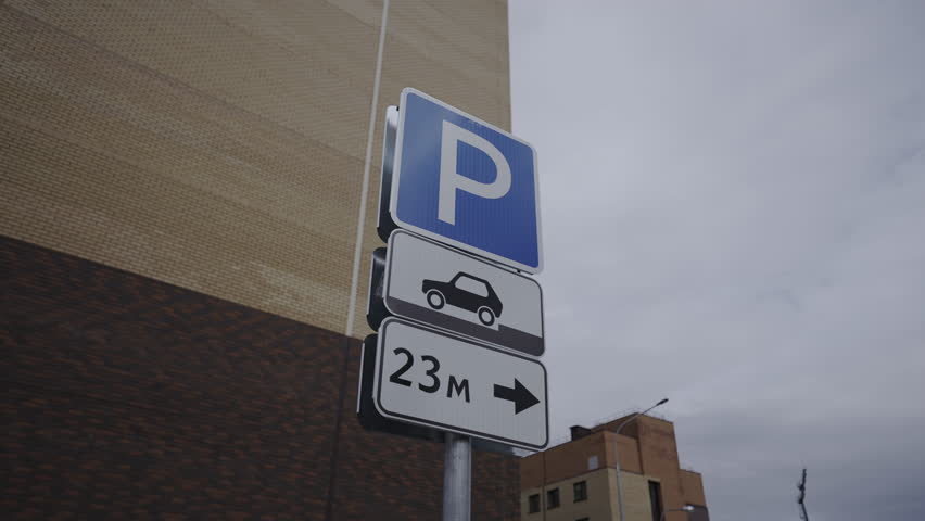 Traffic signals near modern residential building closeup. Signs define parking space for vehicles with road directions for drivers