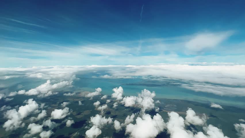 VARADERO, CUBA - DECEMBER 20, 2023: View from the porthole on the Atlantic coast of Cuba. View of the turquoise ocean water and islands with snow-white sand from the plane. White clouds over the water