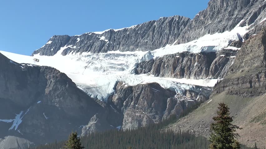 Nature of Canada. Landscapes with mountains, forests, lakes and glaciers. Glacier lake in the Canadian Rocky Mountain Landscape during a vibrant cloudy summer day.