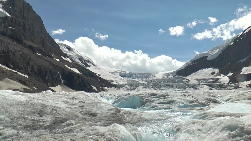Nature of Canada. Landscapes with mountains, forests, lakes and glaciers. Glacier lake in the Canadian Rocky Mountain Landscape during a vibrant cloudy summer day.