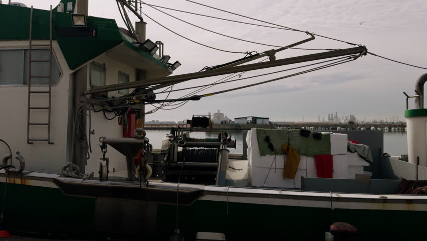 Trawlers in the port of Spain in winter. Fishing boats are moored at the pier. A port in the Mediterranean Sea on a sunny day in February.