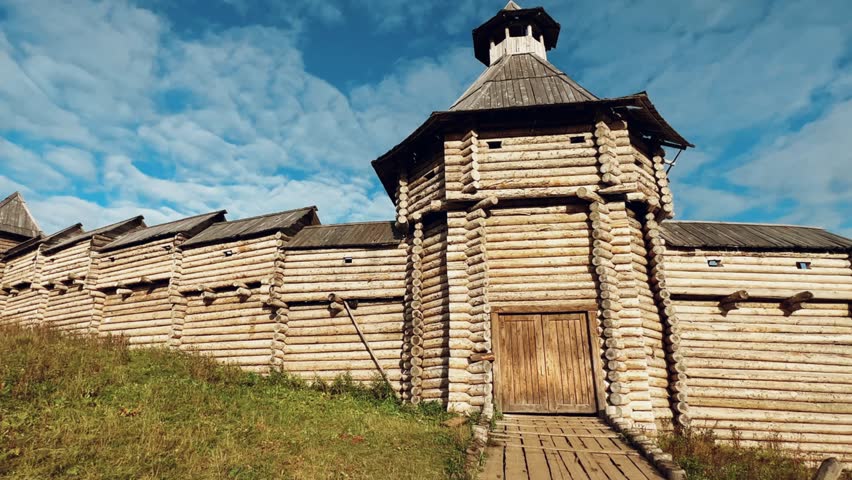 The scenery for the film The Heart of Parma in the Perm region. A large log fortress in the open air in the golden autumn. Autumn panoramic view of the fortress in the rays of the sun.