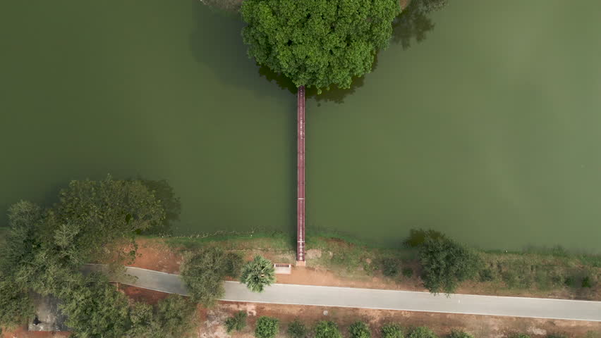 View from the sky of a person entering a reservoir bridge
