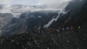 group of people hiking, aerial video, Kamchatka, Russia. people hikers climbing mountain, team work, travelling, trekking